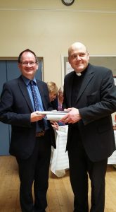 Mark Wardil, Rector's Churchwarden presents Fr Brian with gifts to mark the occasion 